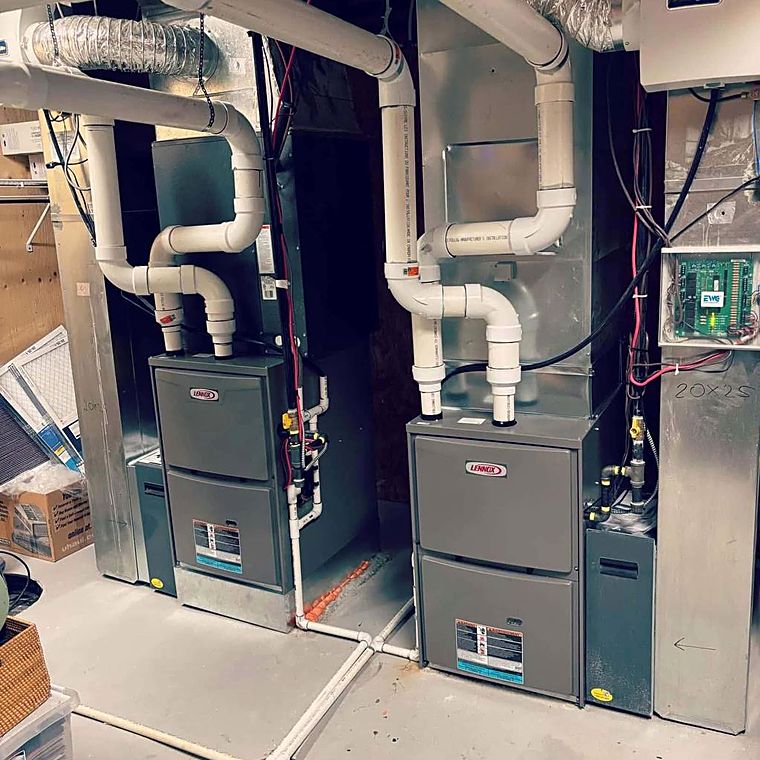 Two furnaces installed side by side with new venting